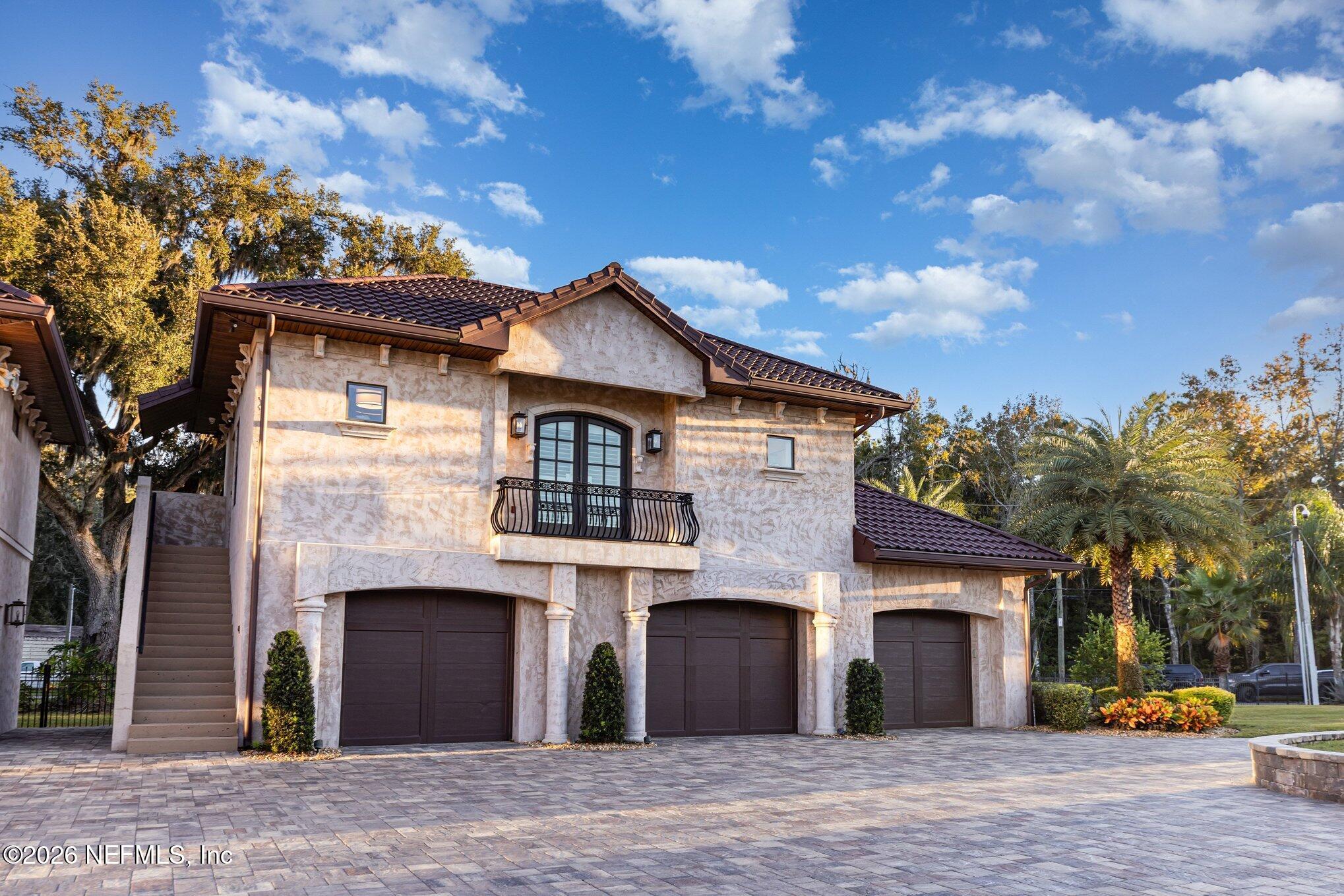 1402 Wilkies Point Road Green Cove Springs, FL 32043 - Photo 16 of 95 a front view of a house with a garden