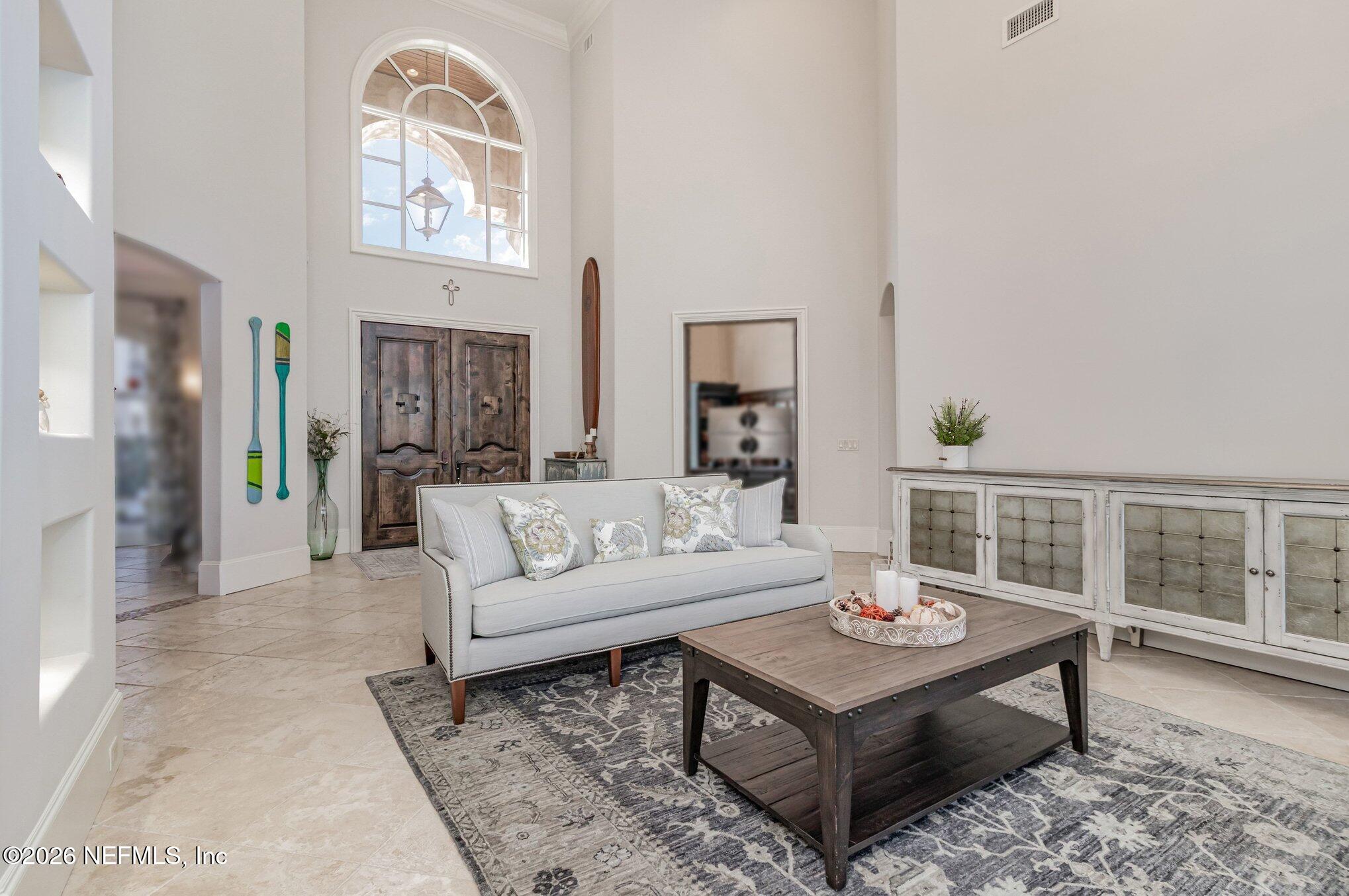 1402 Wilkies Point Road Green Cove Springs, FL 32043 - Photo 28 of 95 a living room with furniture a rug and a window