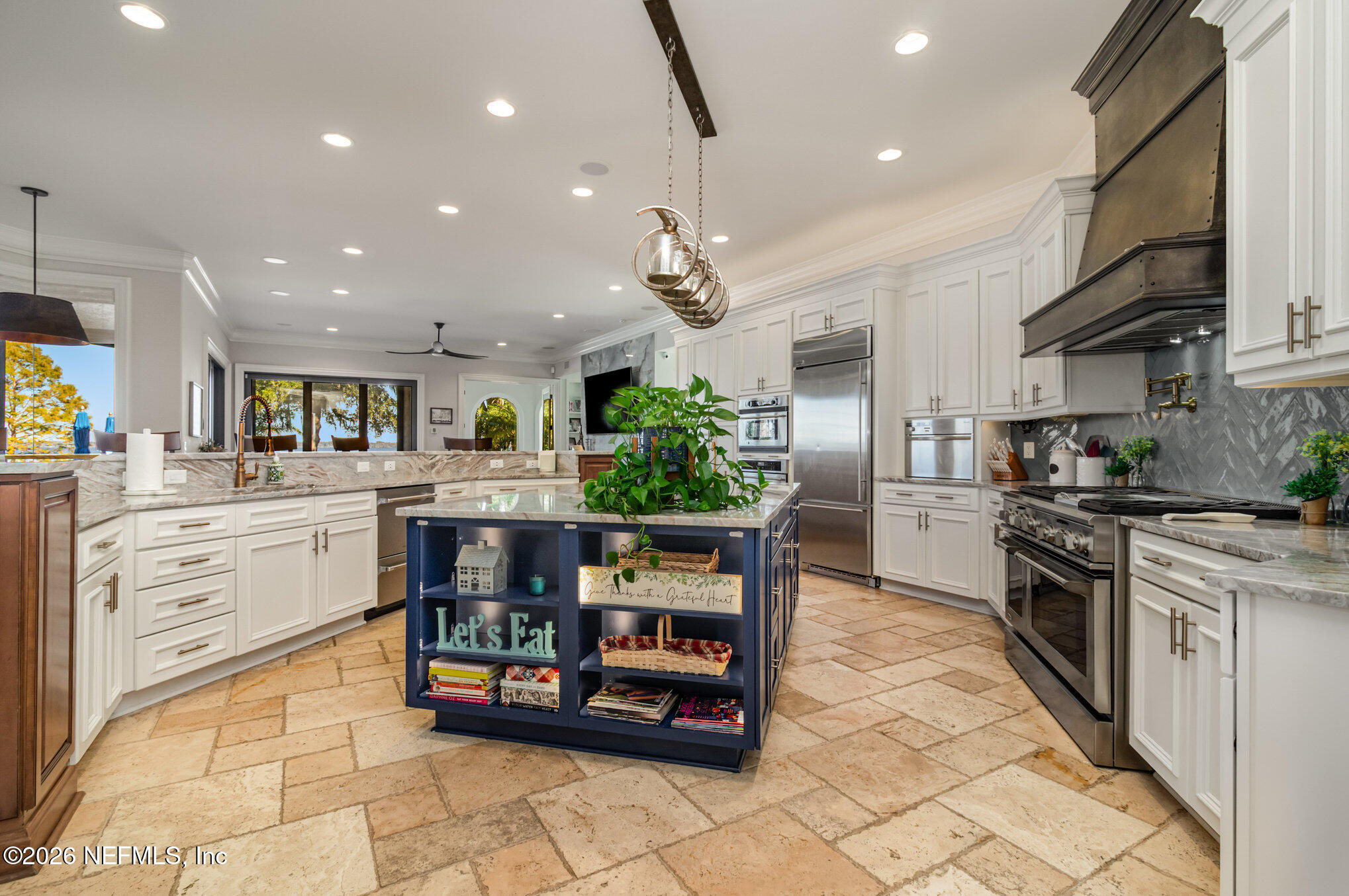 1402 Wilkies Point Road Green Cove Springs, FL 32043 - Photo 33 of 95 a kitchen with stainless steel appliances kitchen island granite countertop a refrigerator and stove