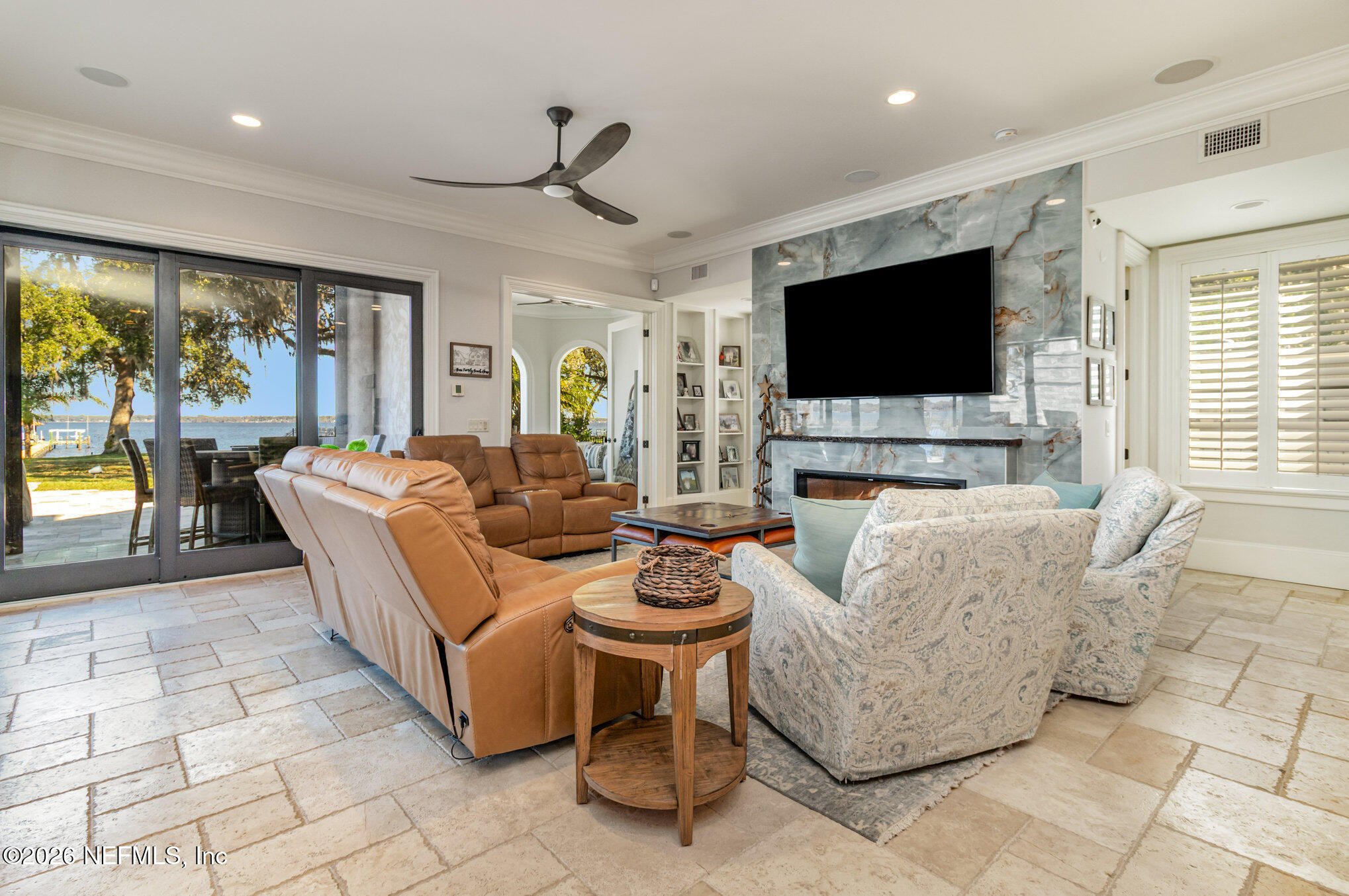 1402 Wilkies Point Road Green Cove Springs, FL 32043 - Photo 40 of 95 a living room with fireplace furniture and a flat screen tv