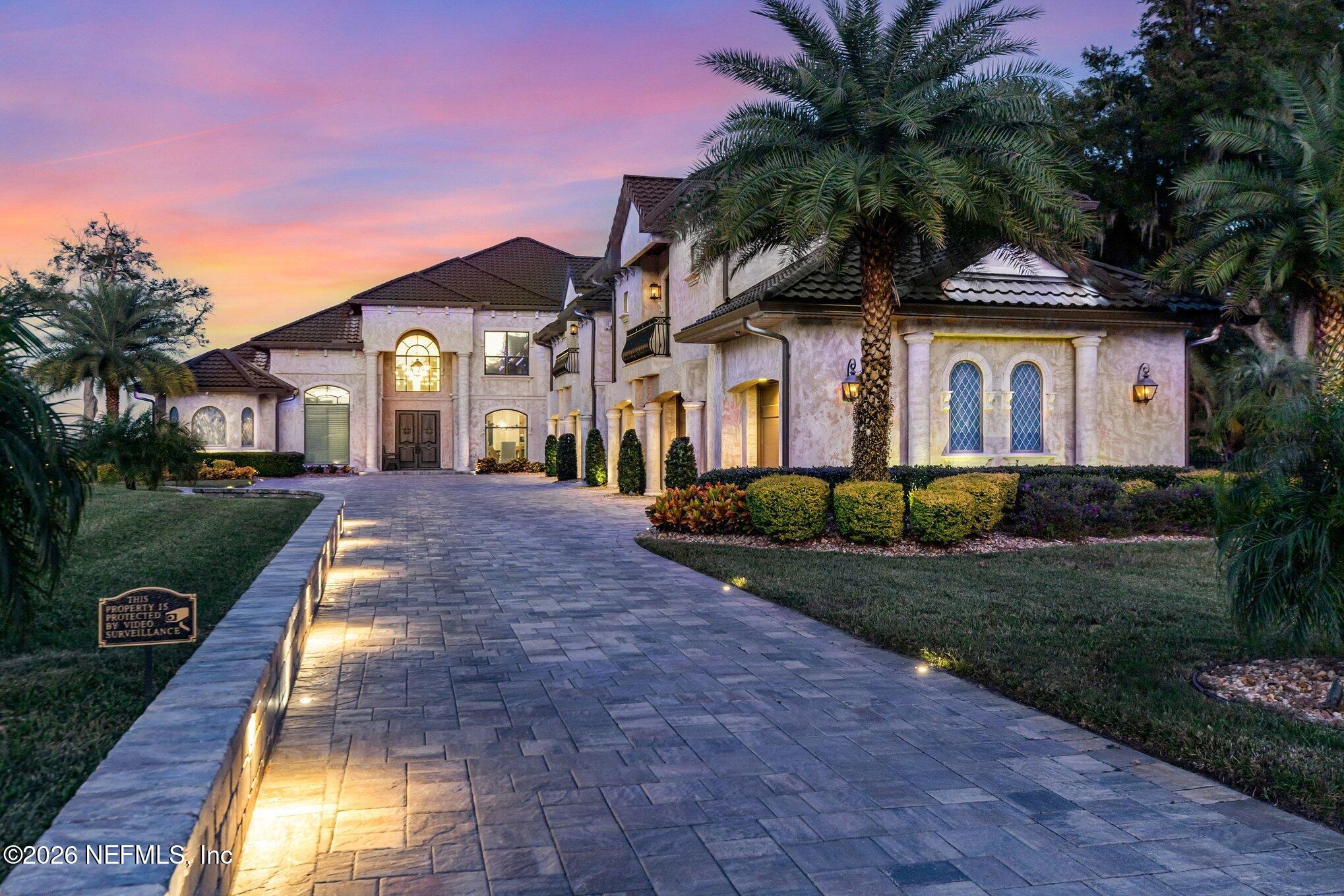 1402 Wilkies Point Road Green Cove Springs, FL 32043 - Photo 4 of 95 a front view of a house with a yard and potted plants