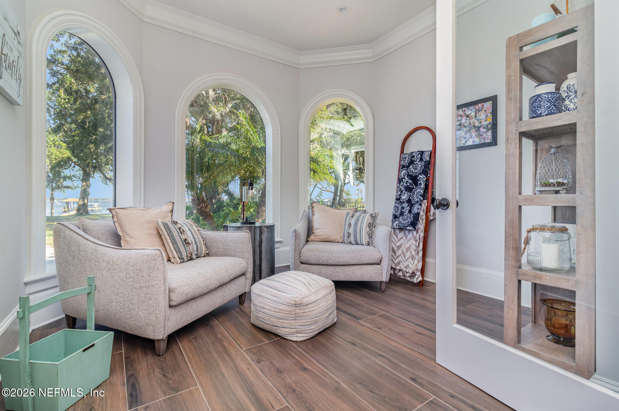 1402 Wilkies Point Road Green Cove Springs, FL 32043 - Photo 44 of 95 a living room with furniture and a floor to ceiling window