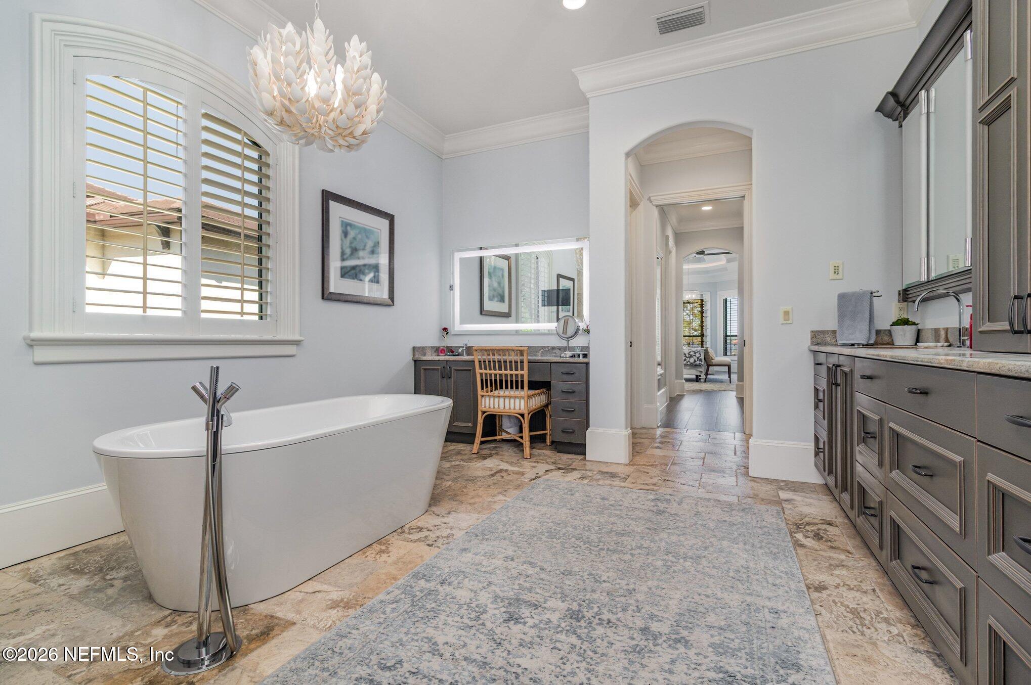 1402 Wilkies Point Road Green Cove Springs, FL 32043 - Photo 48 of 95 a spacious bathroom with a tub sink and a mirror