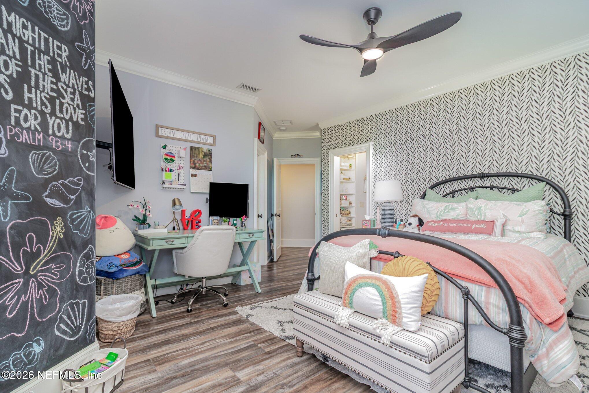 1402 Wilkies Point Road Green Cove Springs, FL 32043 - Photo 58 of 95 a bedroom with a bed and a chandelier