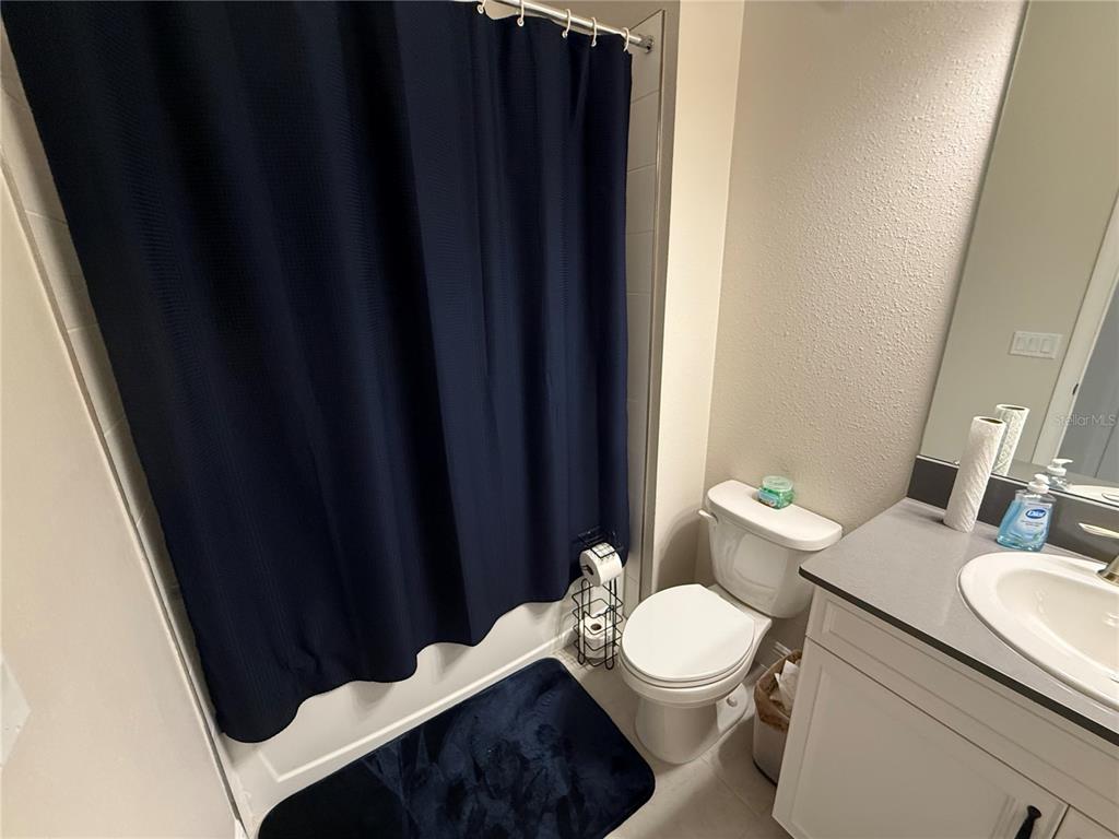 10958 Rustic Timber Loop San Antonio, FL 33576 - Photo 27 of 48 a bathroom with a toilet a sink and a mirror