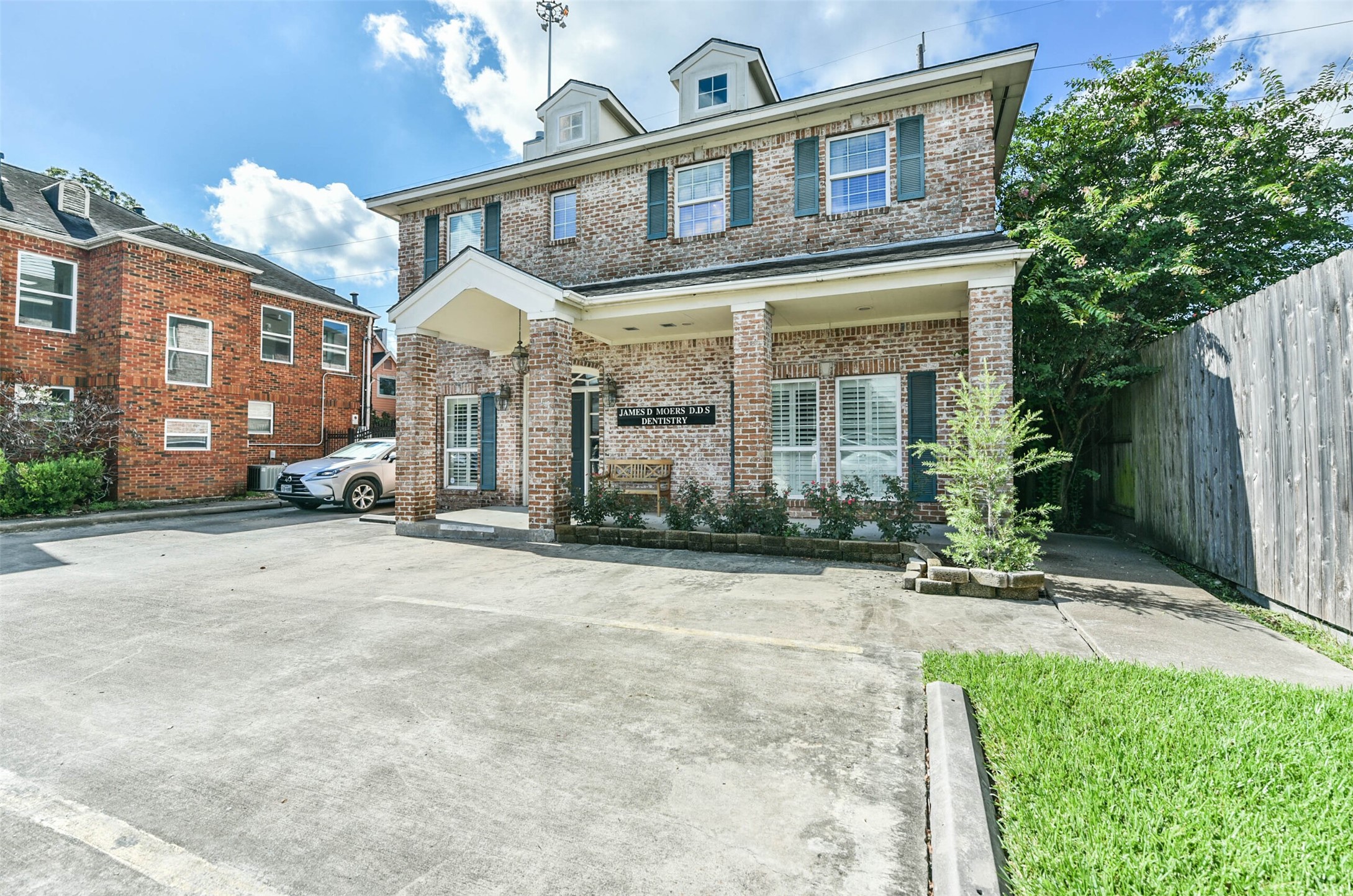 a view of a building with a yard in front of it