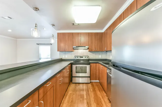 a kitchen with a sink a stove and cabinets