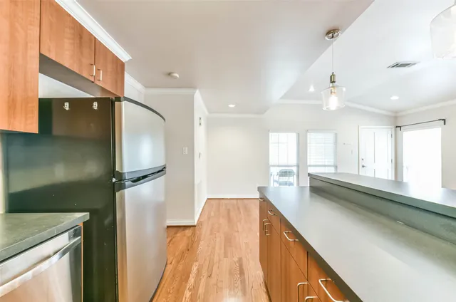 a kitchen with stainless steel appliances granite countertop a sink a window and a counter space