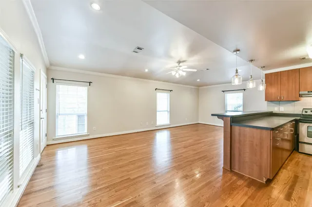a view of a kitchen cabinets a sink and dishwasher a refrigerator with wooden floor