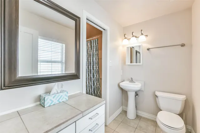 a view of an empty room with a chandelier fan