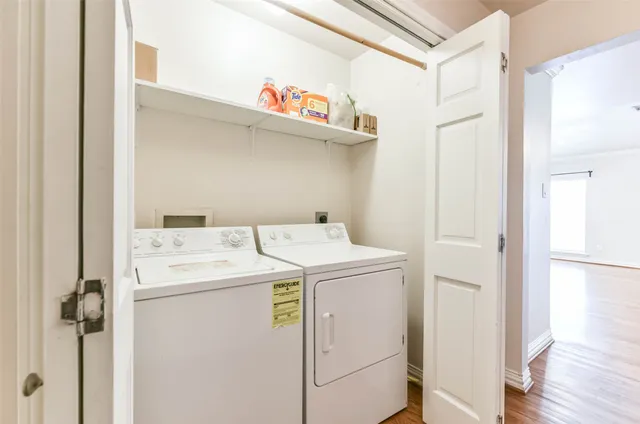 an empty room with chandelier fan and closet area