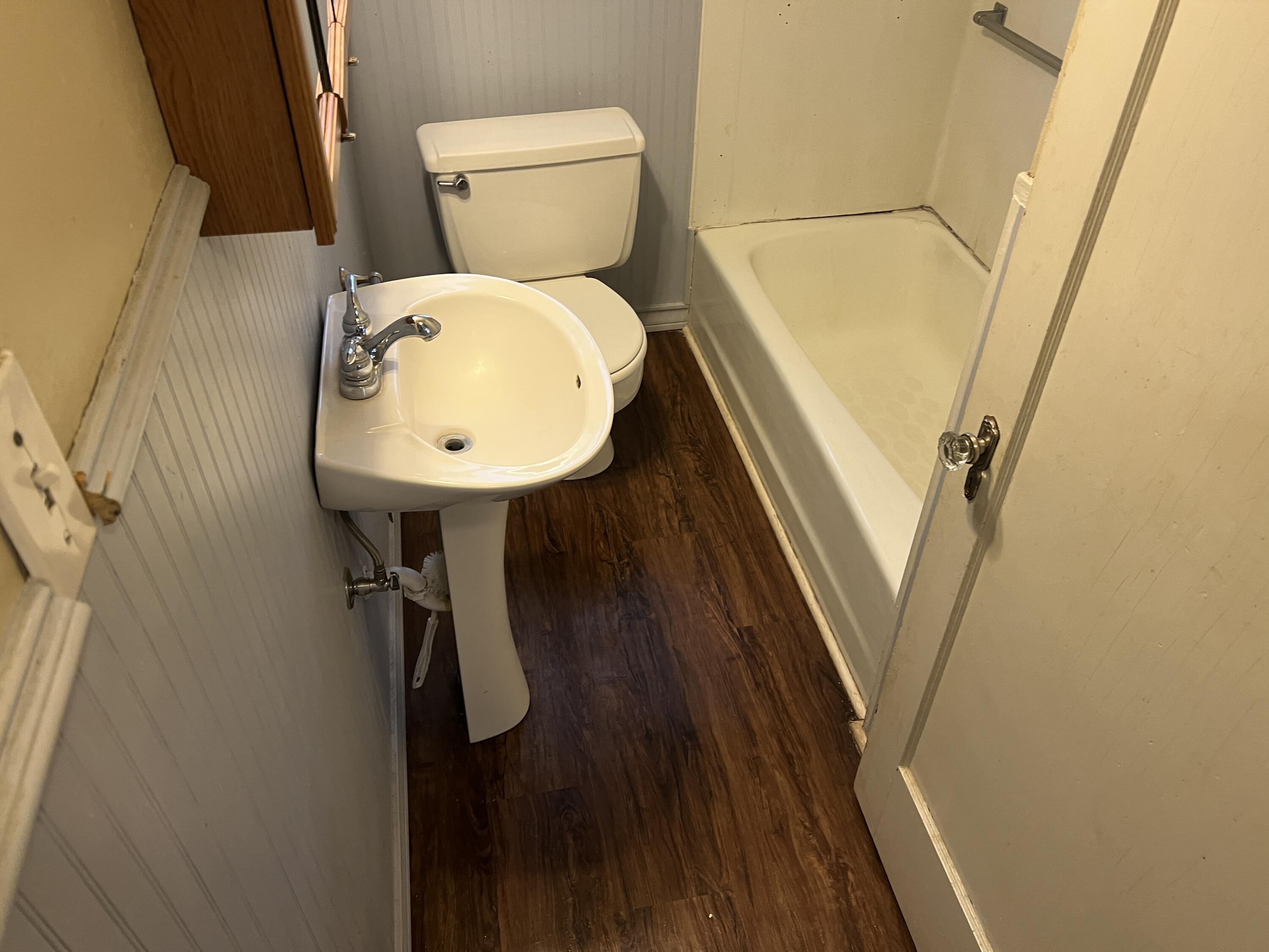 203 Northeast Alpine Plainview, TX 79072 - Photo 12 of 15 a bathroom with a toilet and a sink