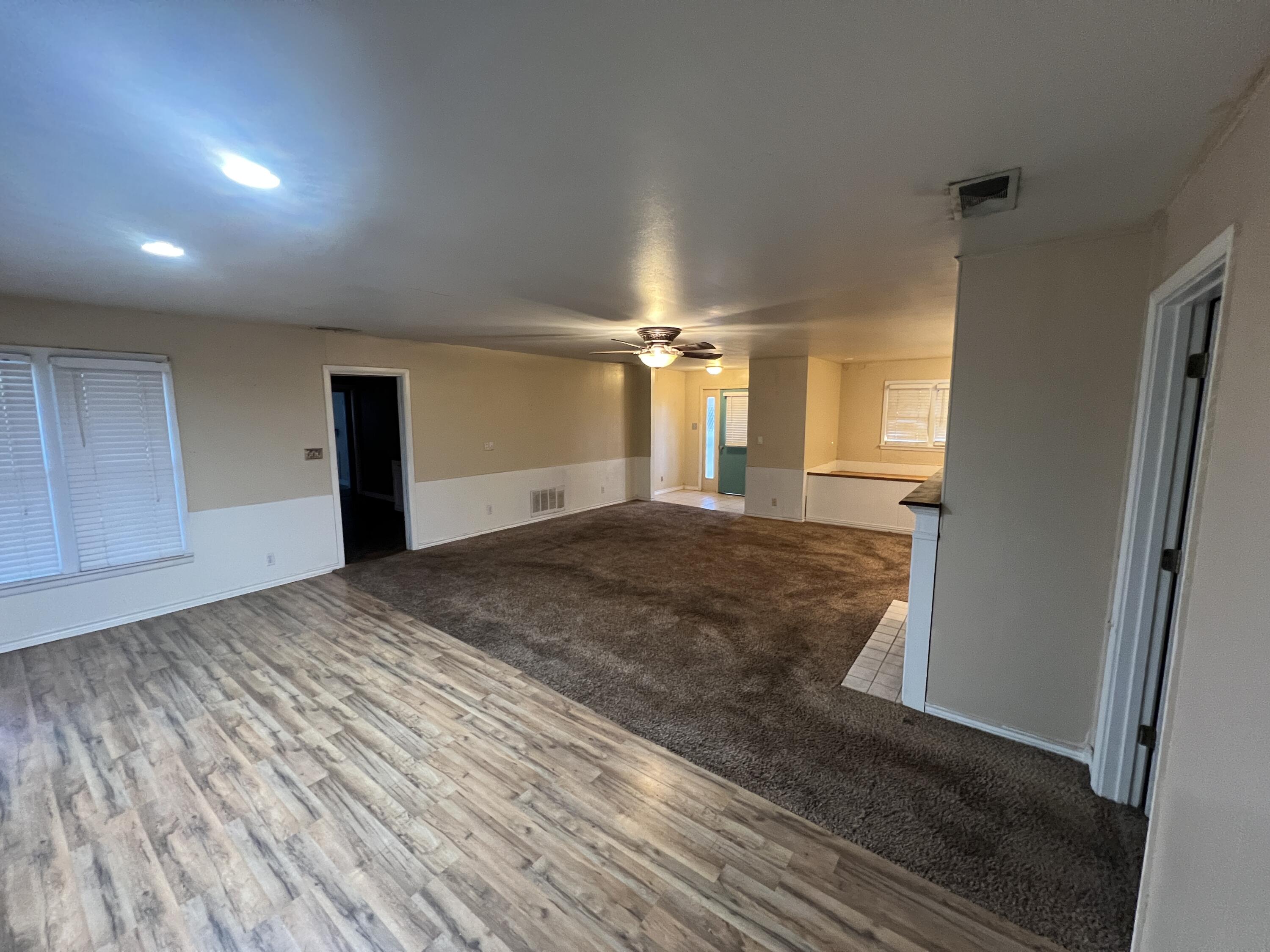 203 Northeast Alpine Plainview, TX 79072 - Photo 3 of 15 a view of a empty room with closet and windows