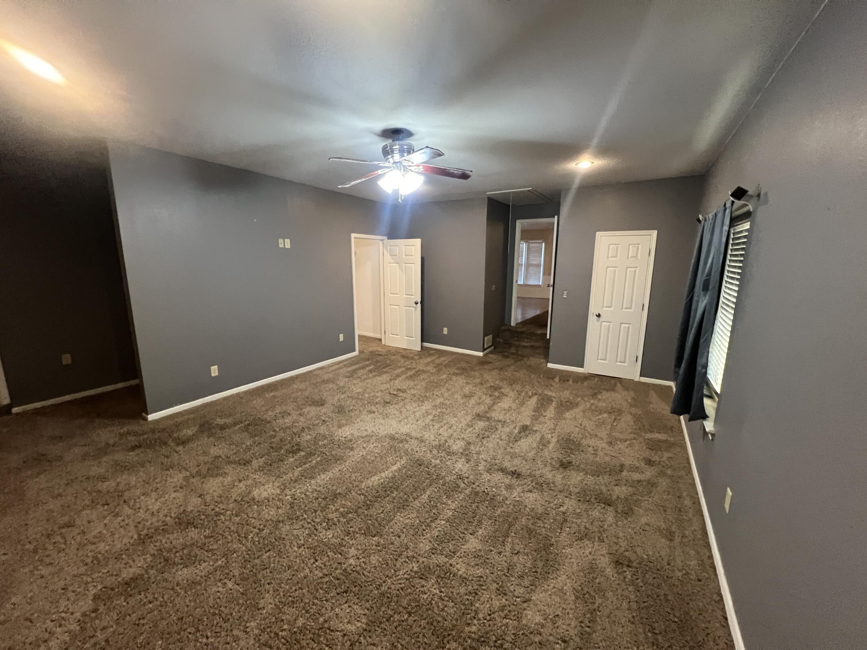 203 Northeast Alpine Plainview, TX 79072 - Photo 6 of 15 wooden floor in an empty room with a window