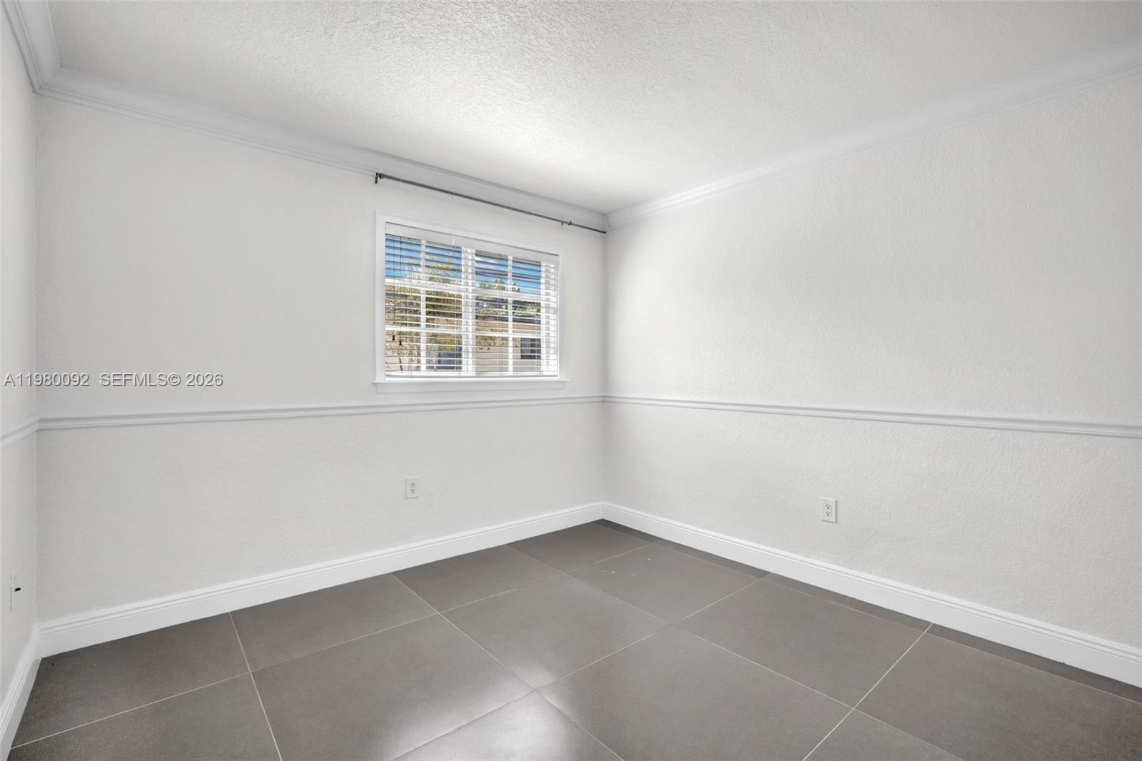 3245 Virginia Street, Unit 26 Miami, FL 33133 - Photo 11 of 26 an empty room with a window