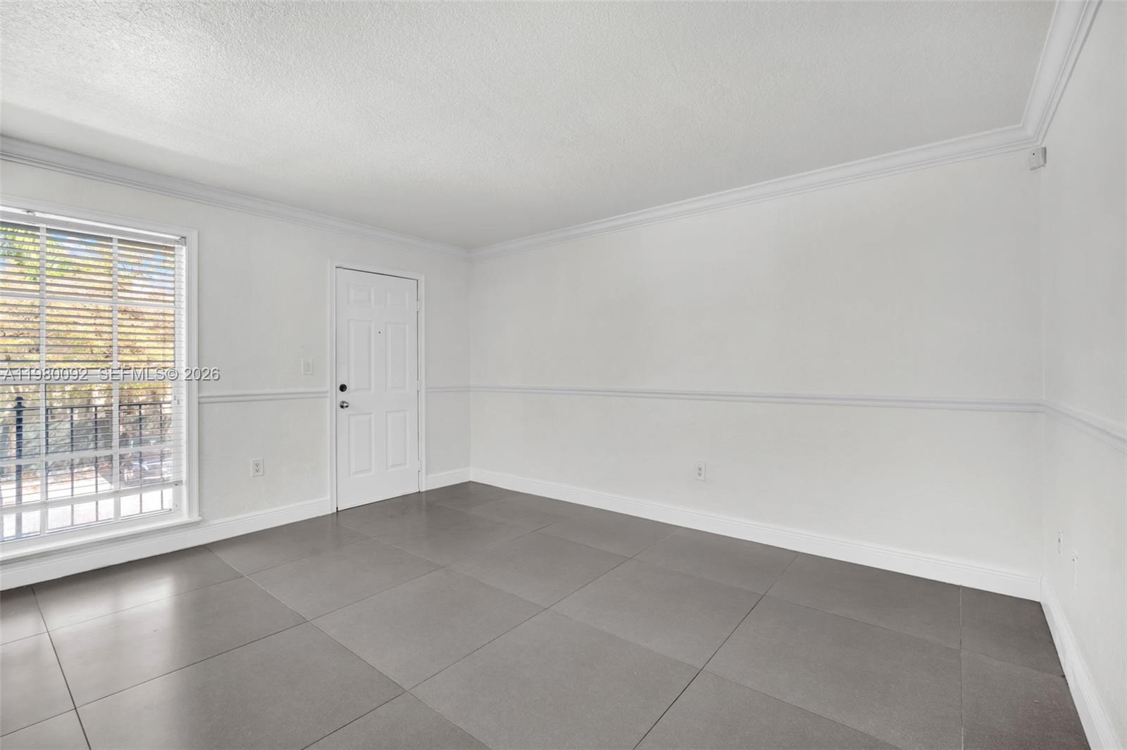 3245 Virginia Street, Unit 26 Miami, FL 33133 - Photo 15 of 26 a view of an empty room with a window