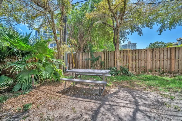 a wooden bench sitting in the middle of a backyard