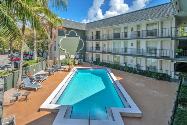 a view of a swimming pool with a lounge chairs