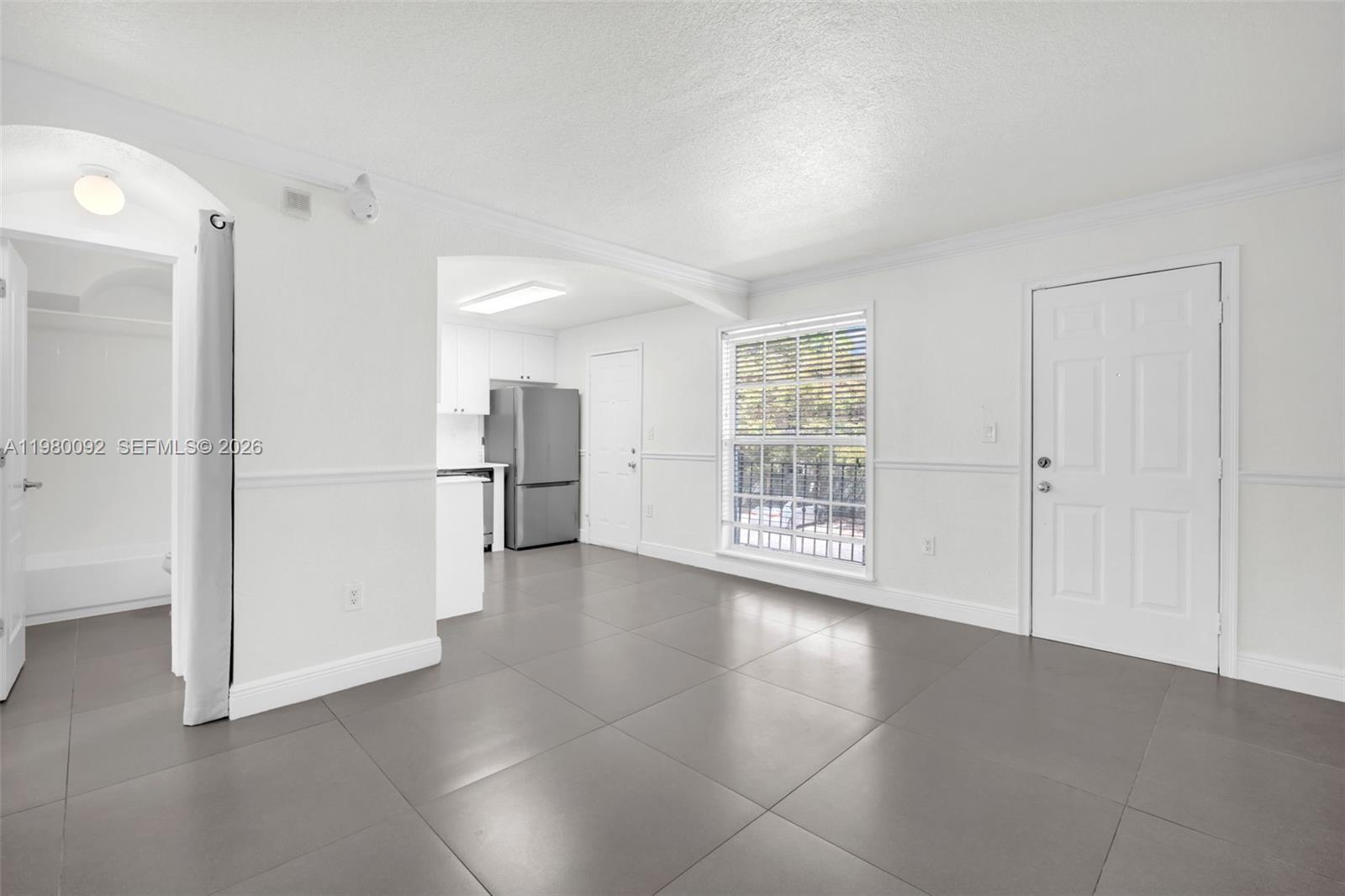 3245 Virginia Street, Unit 26 Miami, FL 33133 - Photo 3 of 26 a view of an empty room with a window