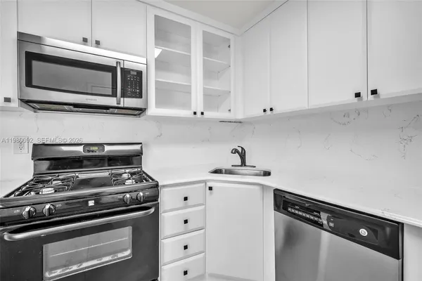 a kitchen with microwave cabinets and stainless steel appliances