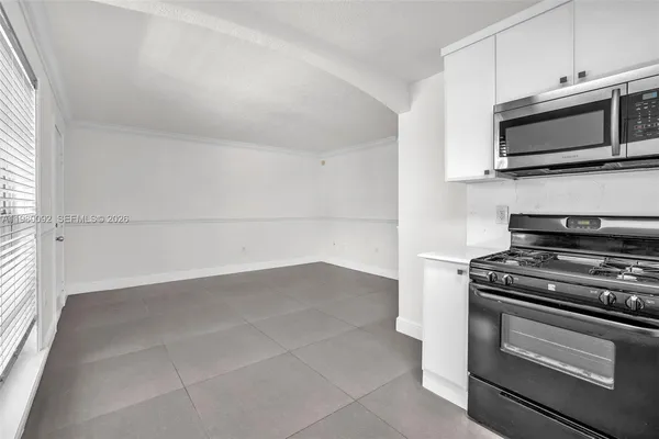 a kitchen with a stove and a microwave