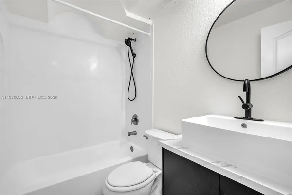 a bathroom with a sink a toilet and a bathtub