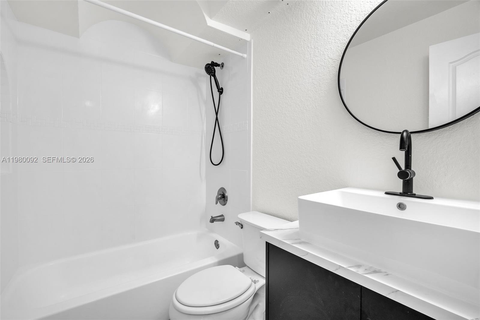 3245 Virginia Street, Unit 26 Miami, FL 33133 - Photo 8 of 26 a bathroom with a sink a toilet and a bathtub