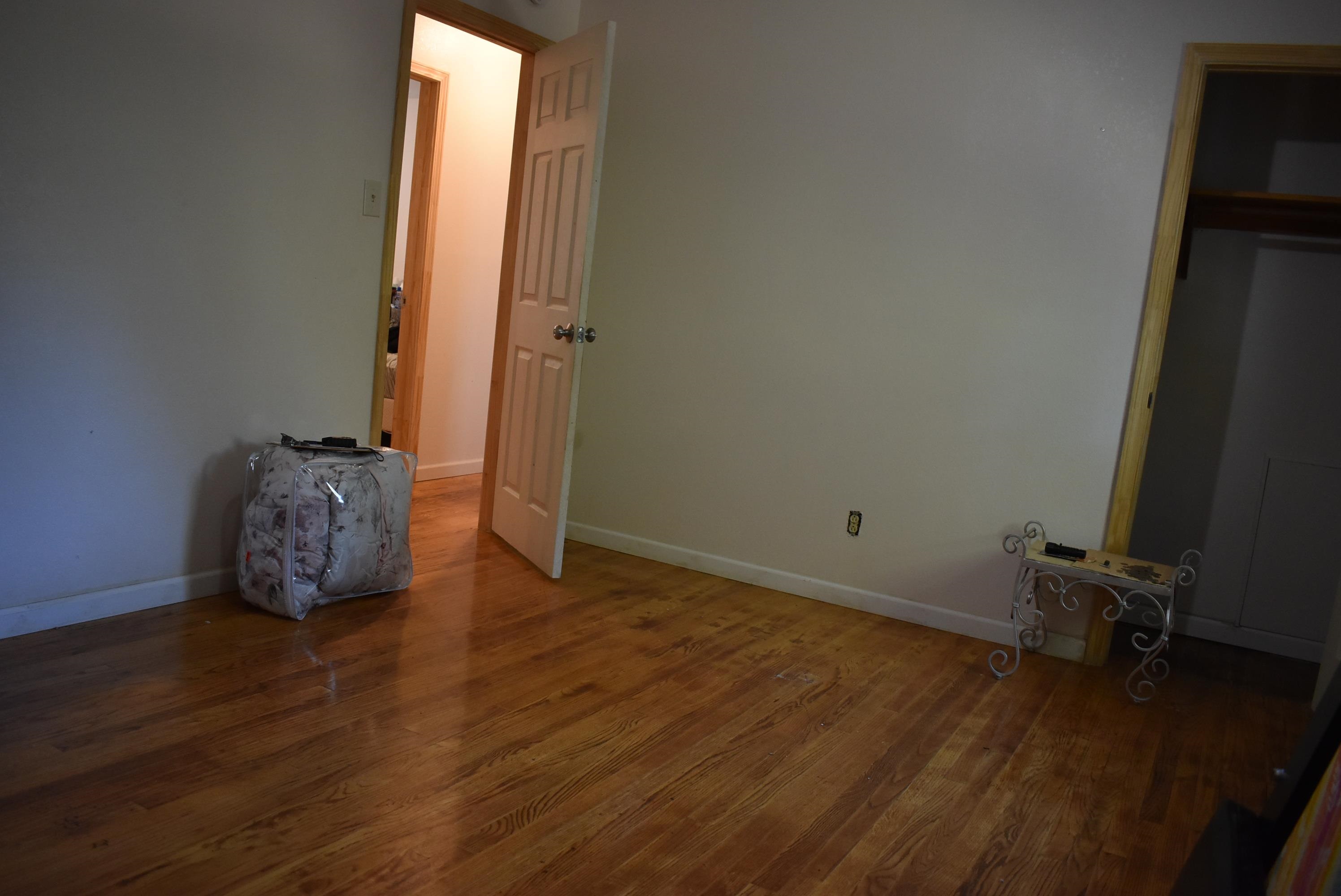 2931 Cherry Road Memphis, TN 38118 - Photo 8 of 11 an empty room with wooden floor and a window