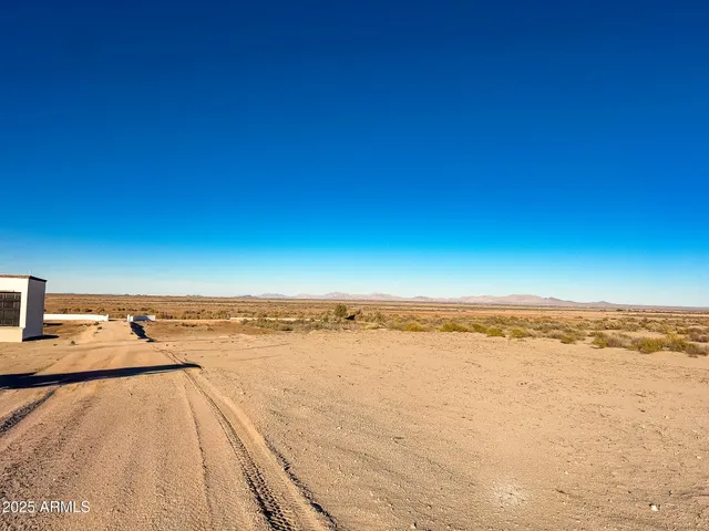a view of roof with two chairs and potted plants