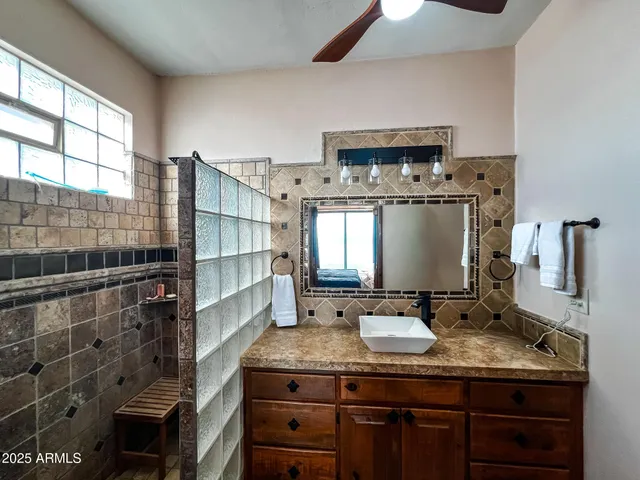 a bath room with a sink and a mirror