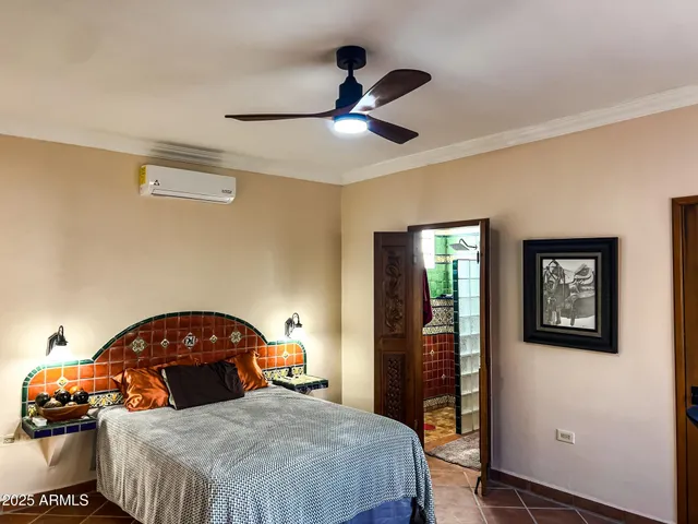 a bedroom with a bed and a chandelier