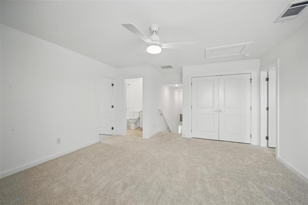 1413 Richardson Street Howe, TX 75459 - Photo 23 of 30 Spacious room featuring neutral carpet, a contemporary ceiling fan, and crisp white walls