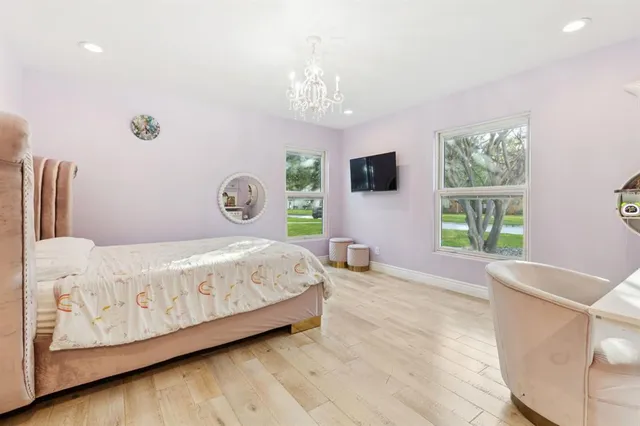 a living room with fireplace furniture and a large window