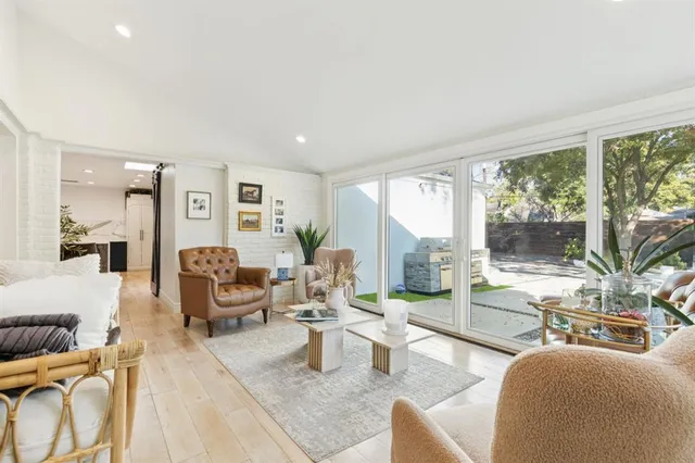 a living room with furniture and large windows