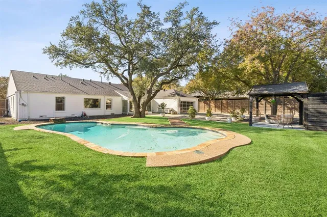 a view of a swimming pool with an outdoor space and seating area