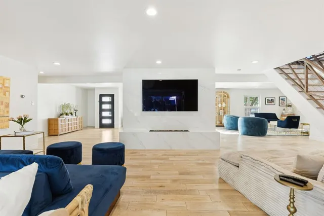 a living room with furniture and a wooden floor