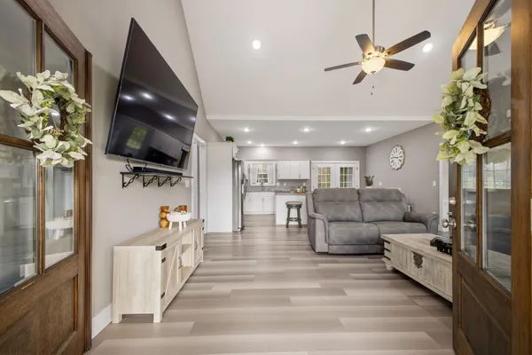 a living room with furniture and a flat screen tv