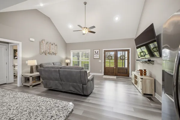 a living room with furniture and kitchen view