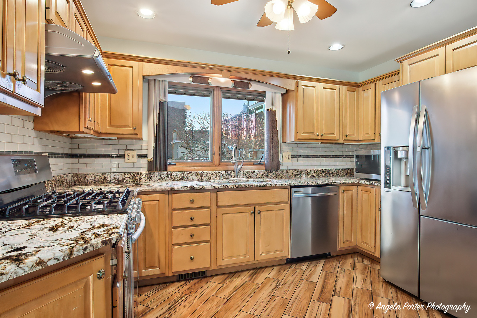 1913 Rancho Lane Des Plaines, IL 60016 - Photo 16 of 36 a kitchen with stainless steel appliances granite countertop a stove and a refrigerator