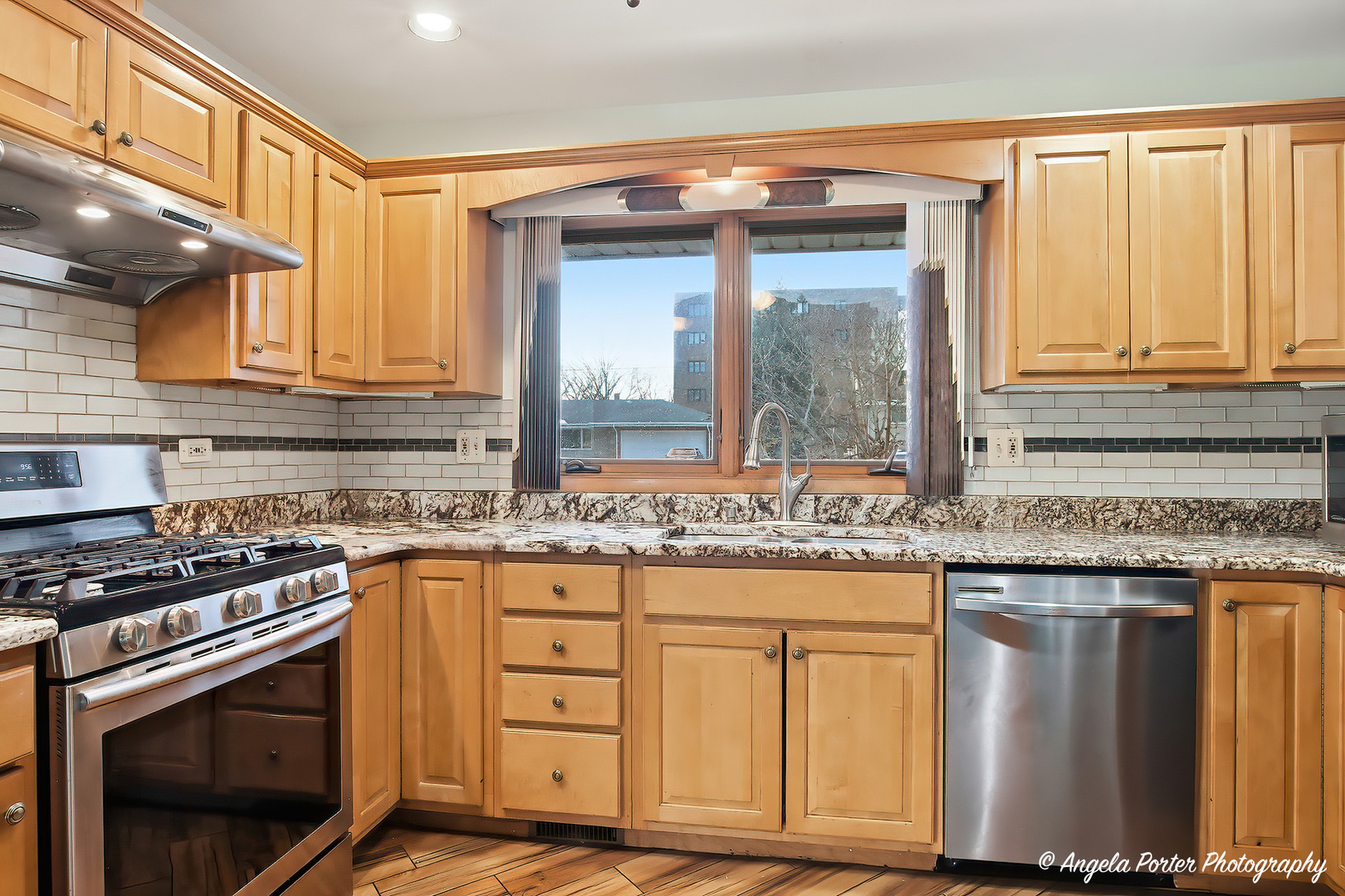 1913 Rancho Lane Des Plaines, IL 60016 - Photo 17 of 36 a kitchen with granite countertop a stove a sink and a refrigerator