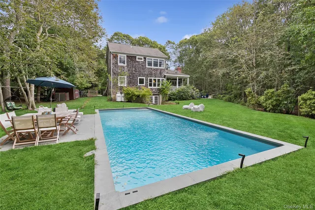 a view of a house with a yard porch and sitting area