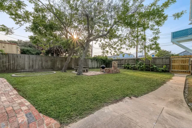 a view of a patio with table and chairs with wooden floor and fence
