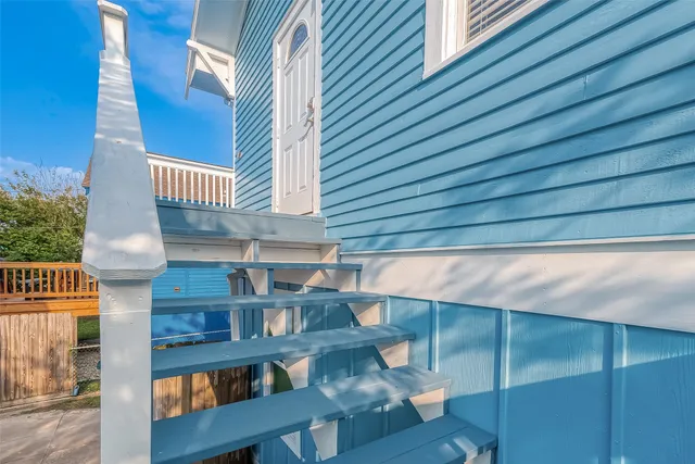 a dining room with wooden floor and chandelier