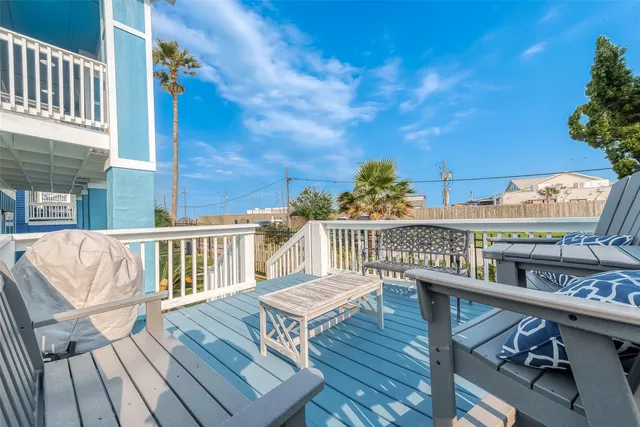 a view of a backyard with a small cabin and wooden fence