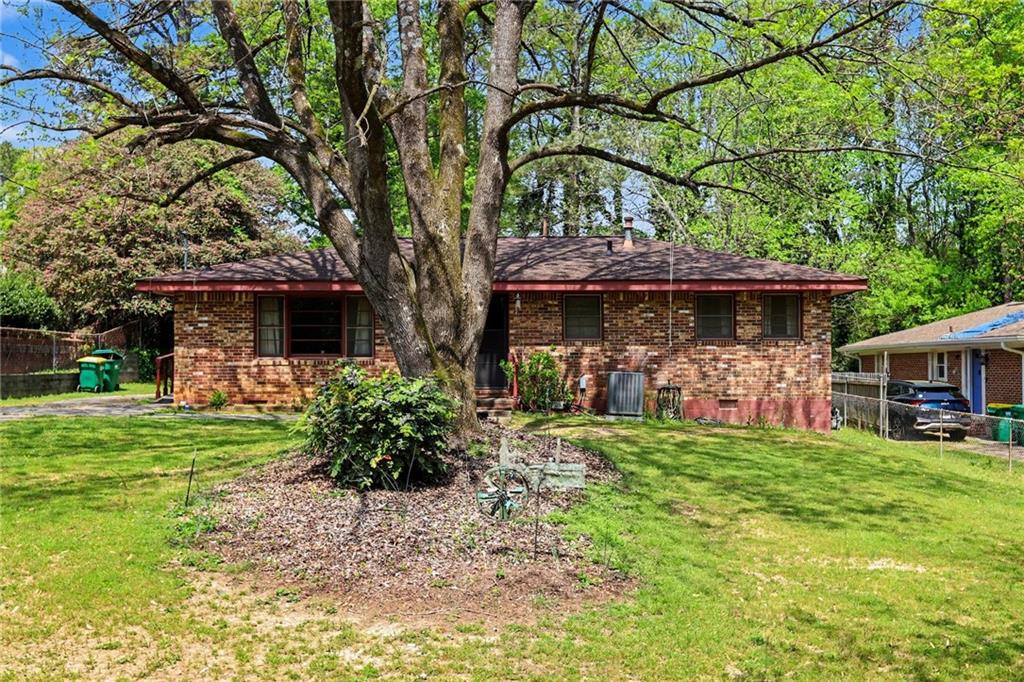 7019 Lake View Lane Doraville, GA 30360 - Photo 1 of 32 a front view of a house with a garden