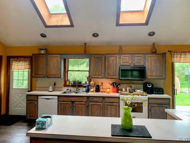 291 Sunset Road Milan, PA 18831 - Photo 35 of 38 a kitchen with stainless steel appliances a stove a sink a microwave a refrigerator and cabinets