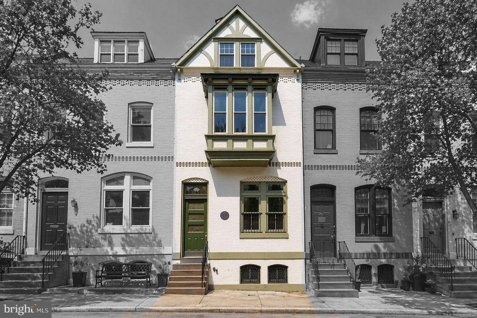 a front view of a residential apartment building with a yard