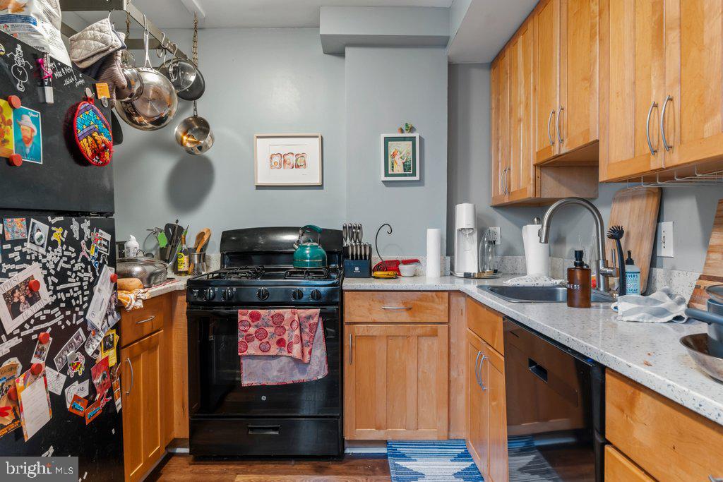 1215 John Street Baltimore, MD 21217 - Photo 15 of 34 a kitchen with stainless steel appliances granite countertop a stove and cabinets