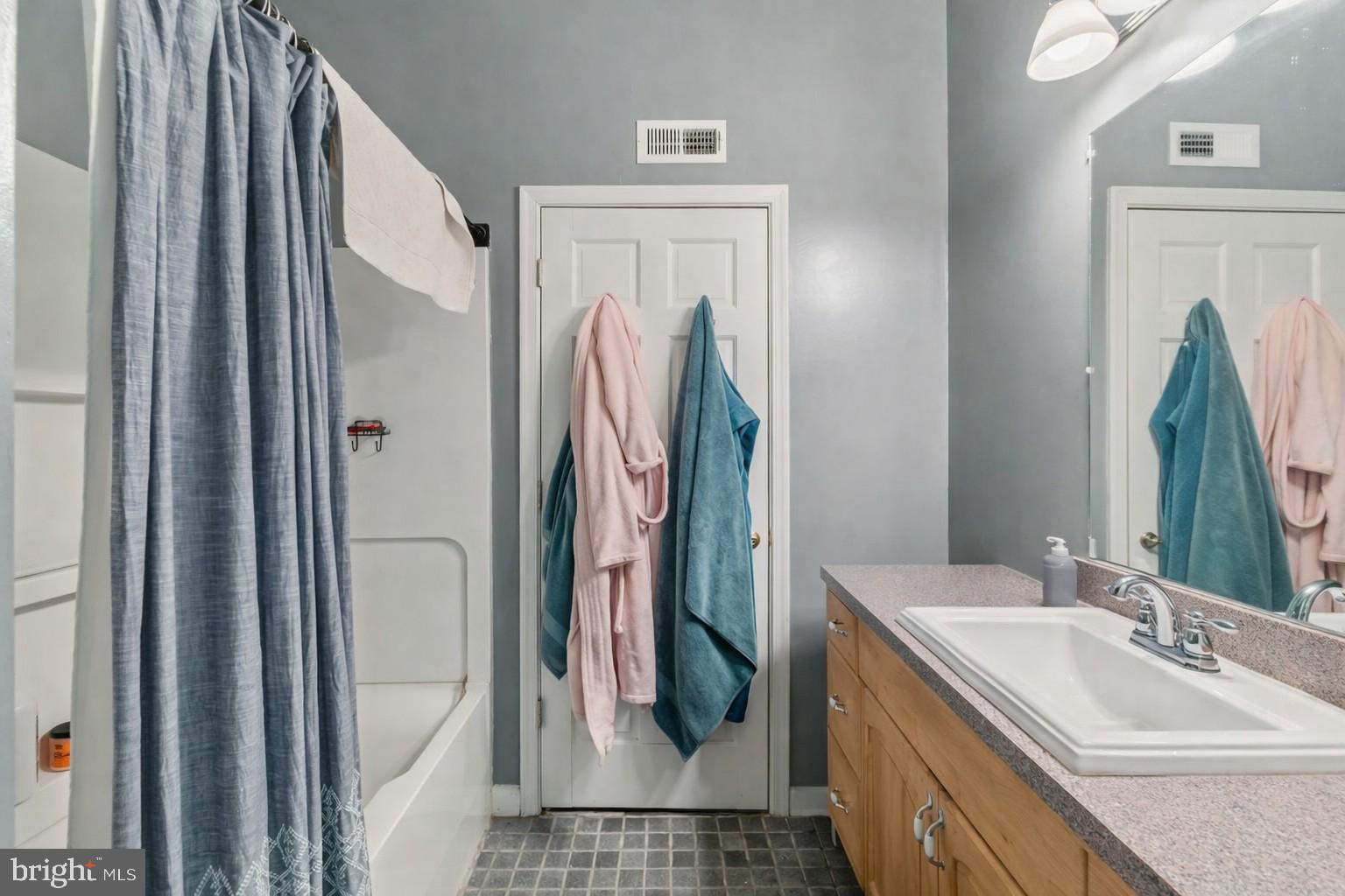 1215 John Street Baltimore, MD 21217 - Photo 16 of 34 a bathroom with a sink a toilet and a mirror