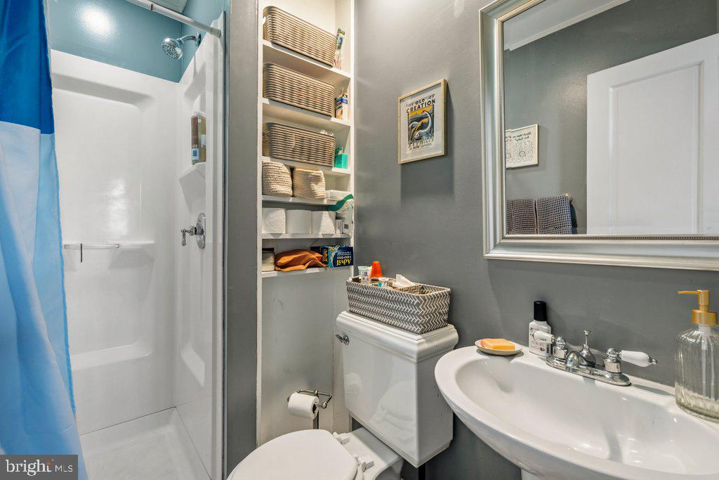 1215 John Street Baltimore, MD 21217 - Photo 19 of 34 a bathroom with a sink toilet and shower